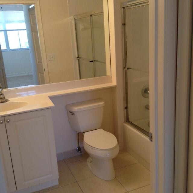 4610 PGA Boulevard, Unit 305 Palm Beach Gardens, FL 33418 - Photo 2 of 10 a bathroom with a toilet and a sink