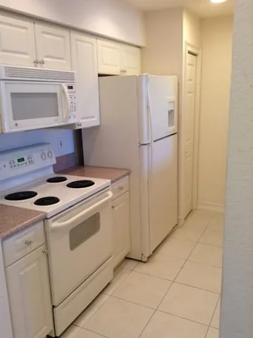 a kitchen with appliances and cabinets