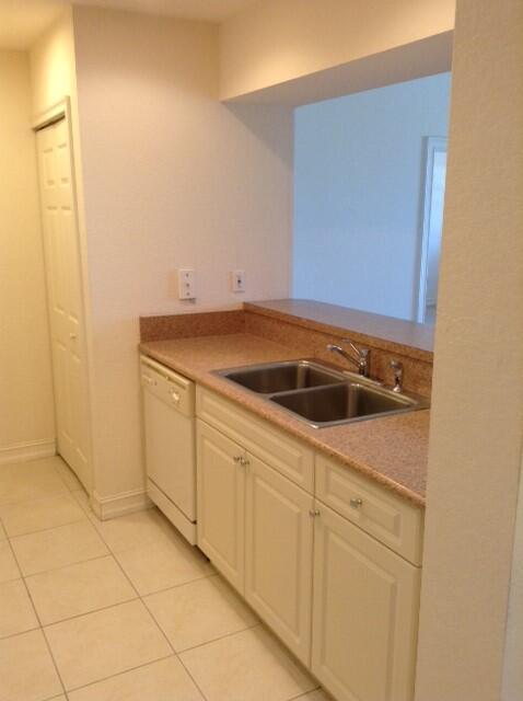 4610 PGA Boulevard, Unit 305 Palm Beach Gardens, FL 33418 - Photo 8 of 10 a utility room with cabinets