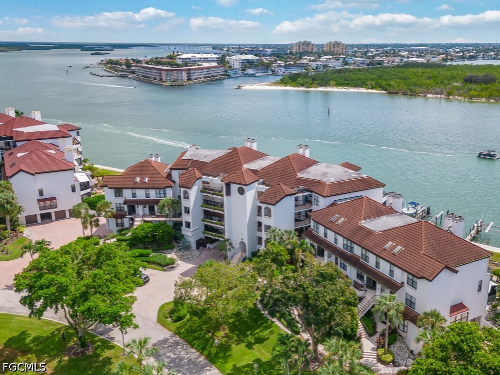 232 La Peninsula Boulevard, Unit 232 Naples, FL 34113 - Photo 28 of 44 an aerial view of house with yard and ocean view