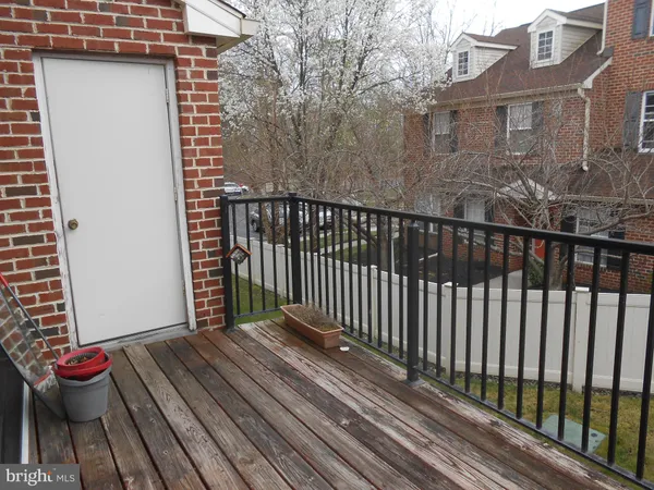 a view of a porch with wooden floor and fence