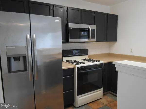 a kitchen with a refrigerator and a microwave