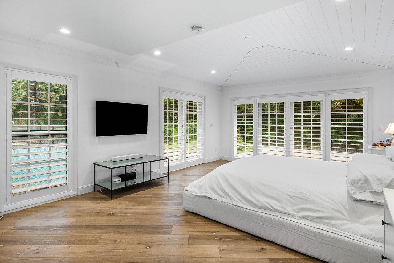 17844 Scarsdale Way Boca Raton, FL 33496 - Photo 13 of 38 a spacious bedroom with a bed and a flat screen television