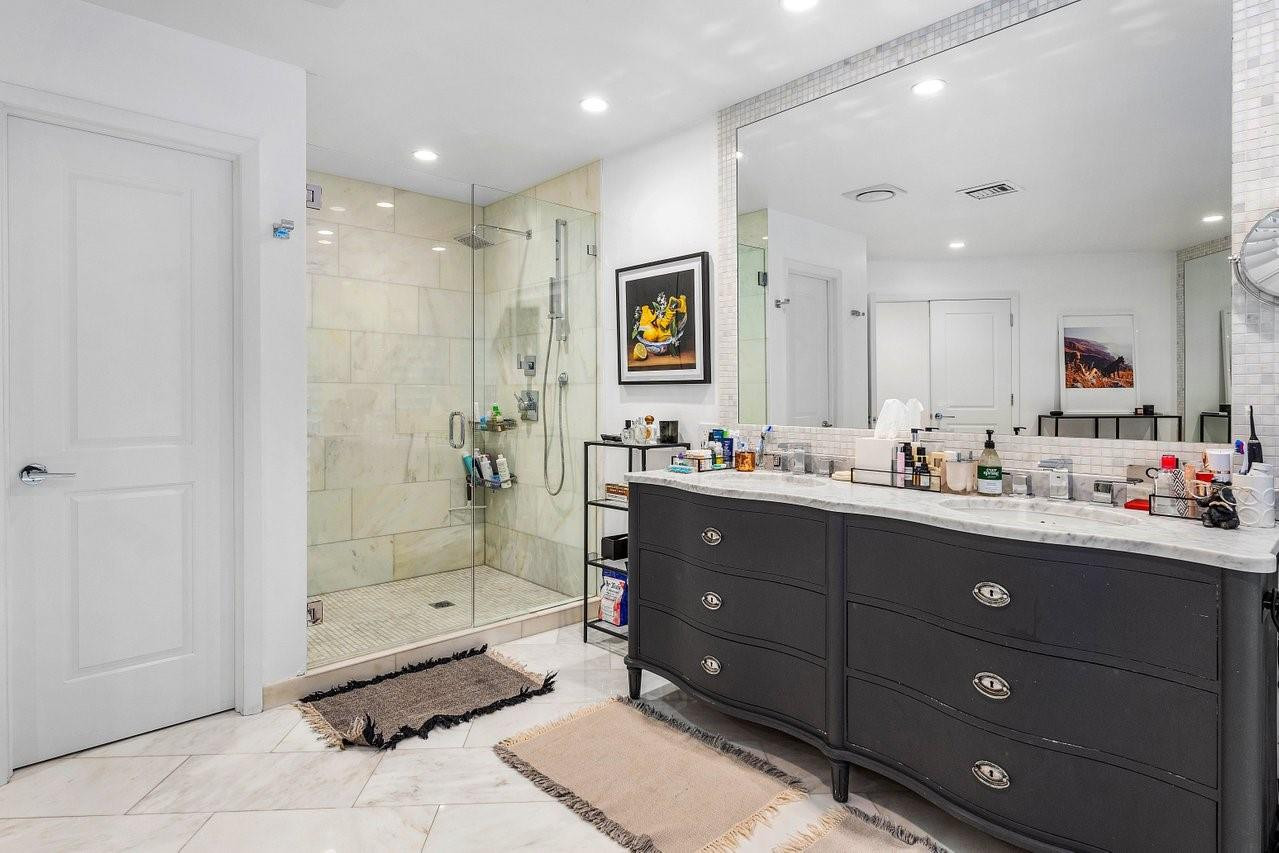 17844 Scarsdale Way Boca Raton, FL 33496 - Photo 16 of 38 a bathroom with a sink vanity granite tub shower and a mirror