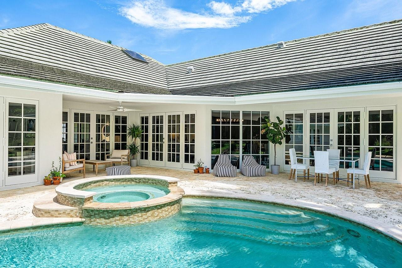 17844 Scarsdale Way Boca Raton, FL 33496 - Photo 26 of 38 a front view of a house with swimming pool and porch