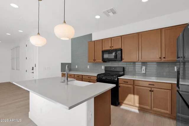 a kitchen with cabinets appliances and a counter top