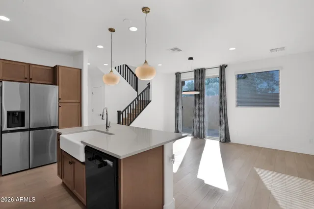 a kitchen with a sink a refrigerator and a stove top oven