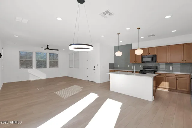 a large white kitchen with a large window