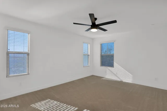 a view of a big room with closet and ceiling fan