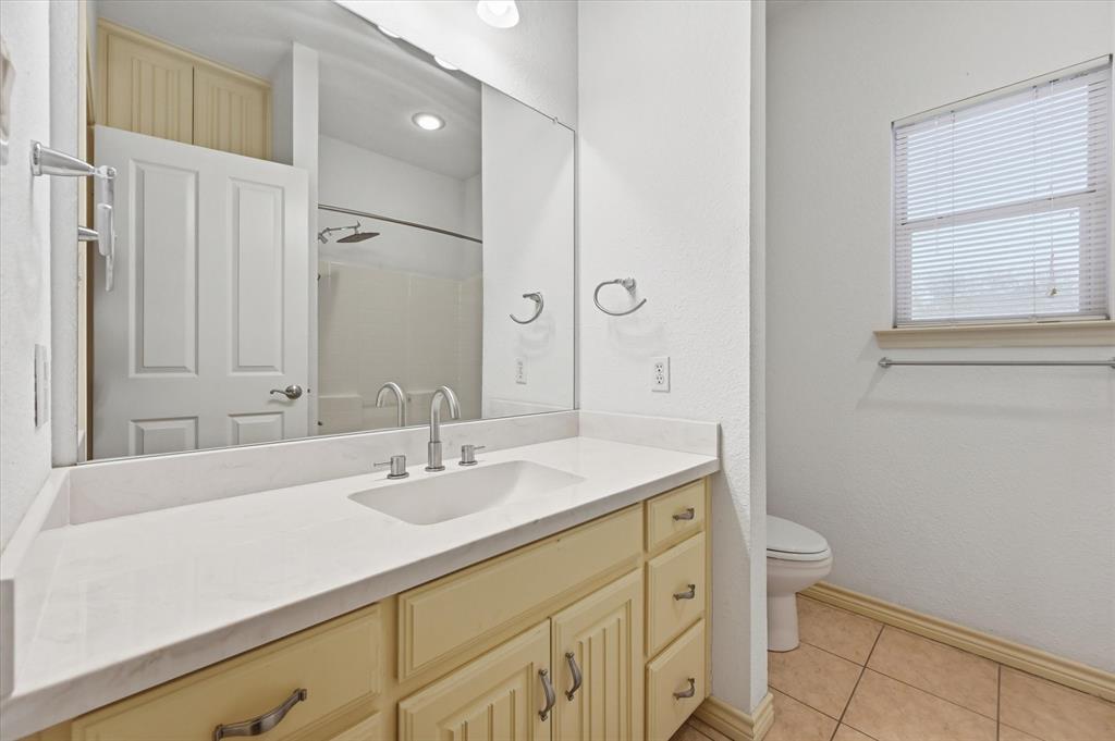 1616 Nash-Howard Road Waxahachie, TX 75165 - Photo 27 of 36 a bathroom with a sink a toilet and a mirror