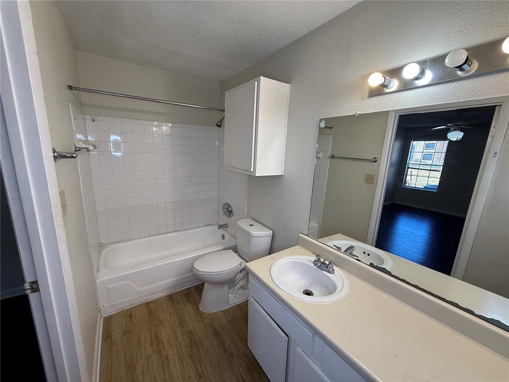 5500 Devonbriar Way, Unit 104 Orlando, FL 32822 - Photo 15 of 24 a bathroom with a sink a toilet and shower