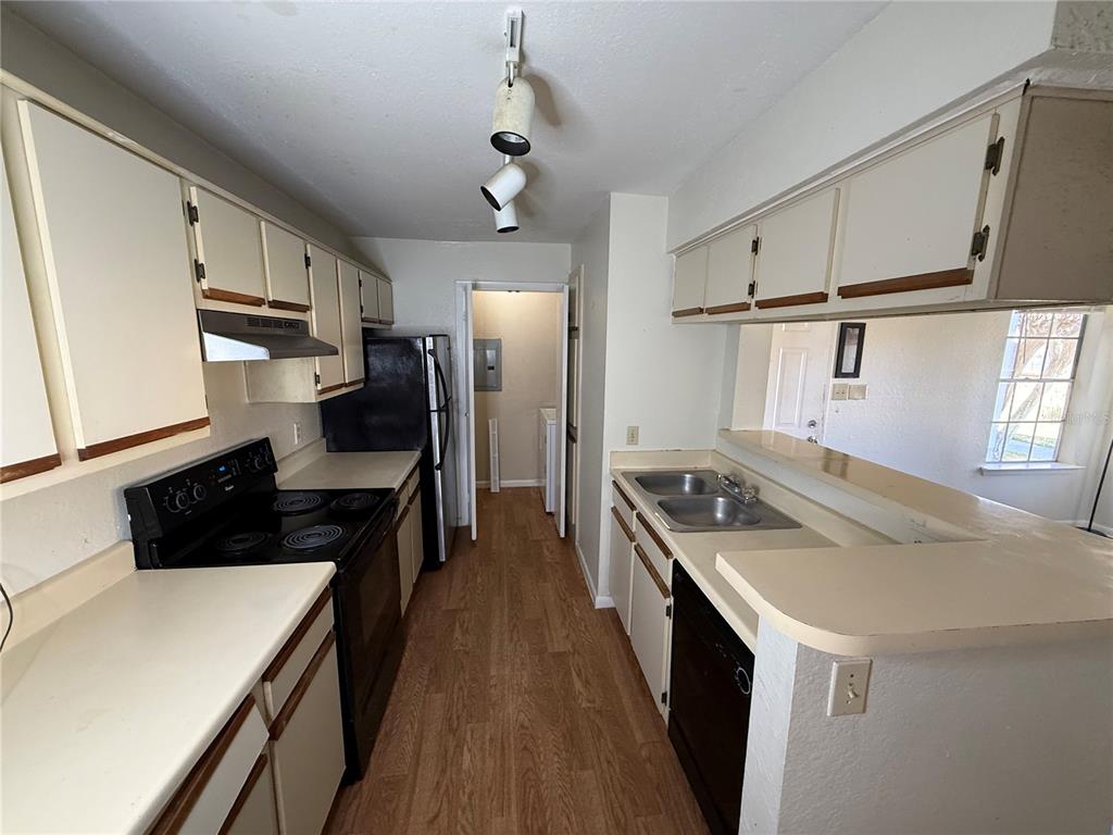 5500 Devonbriar Way, Unit 104 Orlando, FL 32822 - Photo 7 of 24 a kitchen with stainless steel appliances granite countertop a sink stove and refrigerator