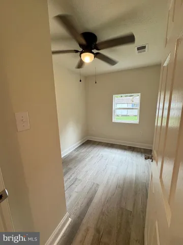 a view of an empty room and a window