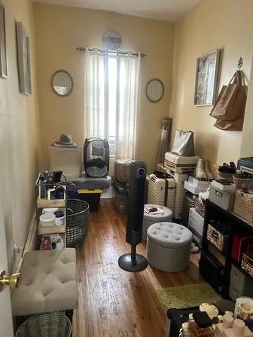 a view of a workspace with furniture and a window