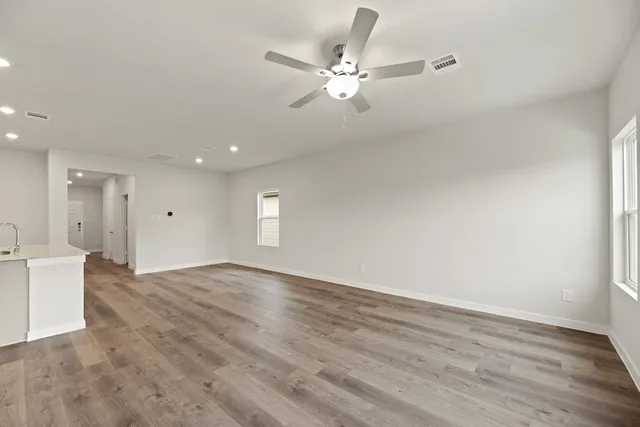 wooden floor in an empty room with a window