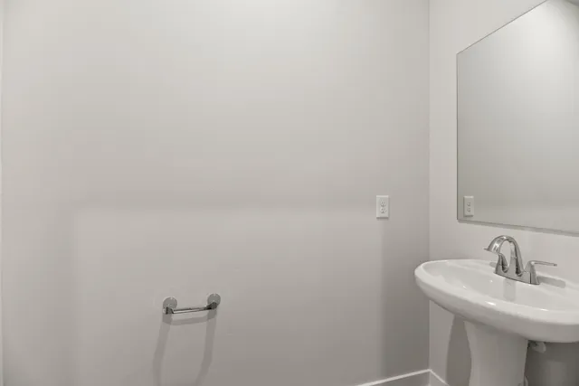 a bathroom with a sink and mirror