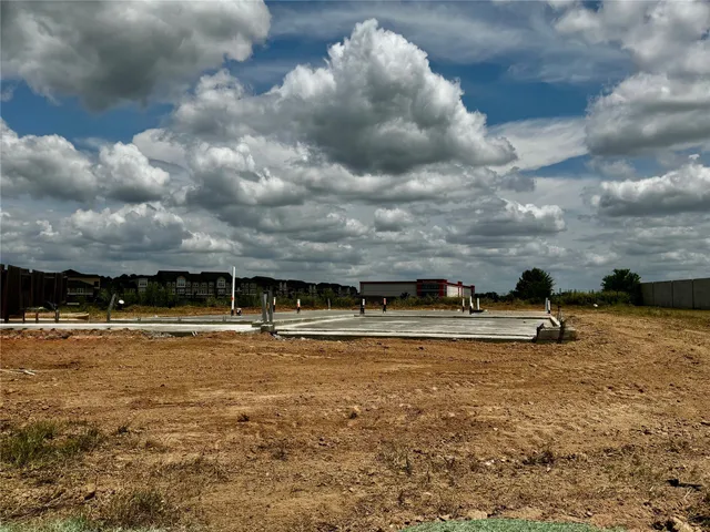 a view of a lake with houses in back