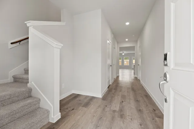 a view of a hallway with wooden floor