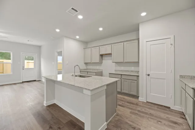 a kitchen with a sink stove and cabinets