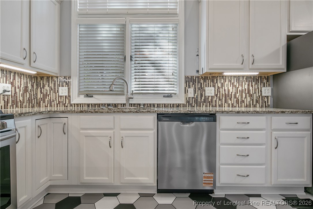 1915 Morganton Road Fayetteville, NC 28305 - Photo 11 of 48 a kitchen with granite countertop white cabinets and sink