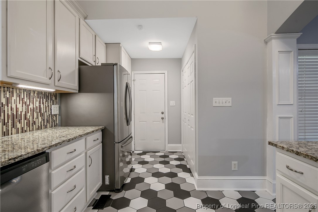 1915 Morganton Road Fayetteville, NC 28305 - Photo 15 of 48 a kitchen with granite countertop a refrigerator and a sink