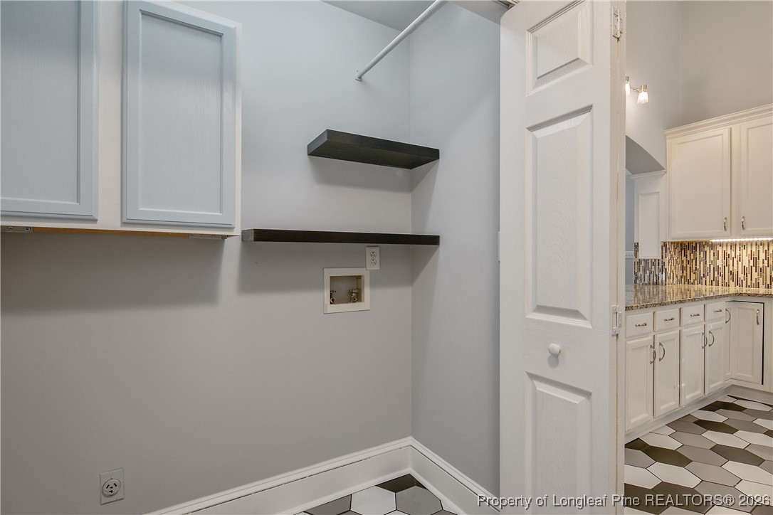 1915 Morganton Road Fayetteville, NC 28305 - Photo 17 of 48 a view of storage and utility room with wooden floor