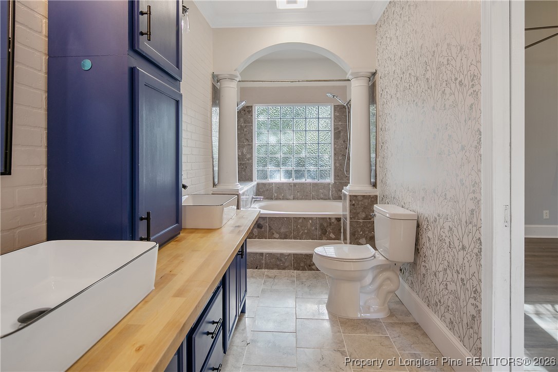 1915 Morganton Road Fayetteville, NC 28305 - Photo 24 of 48 a bathroom with a granite countertop sink a toilet a mirror and shower