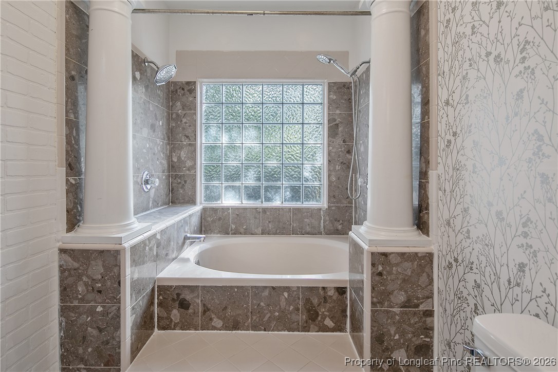 1915 Morganton Road Fayetteville, NC 28305 - Photo 25 of 48 a white bath tub sitting next to a toilet