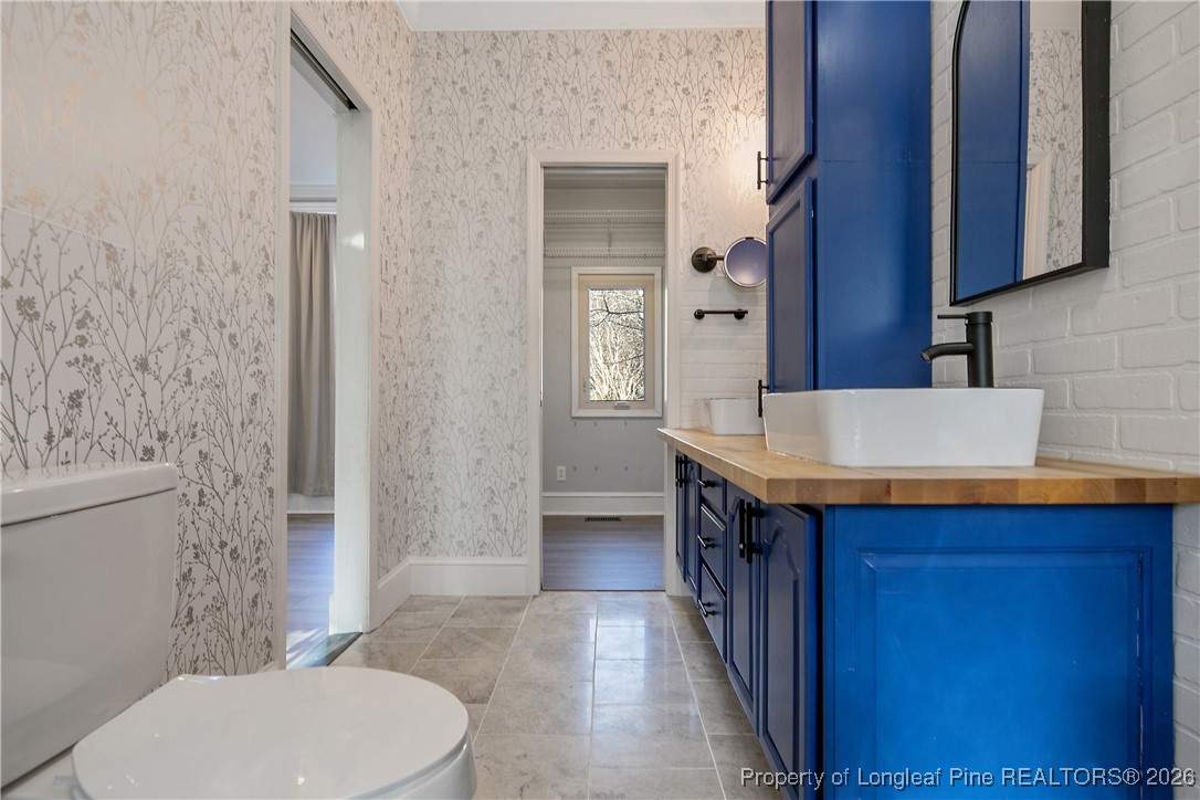 1915 Morganton Road Fayetteville, NC 28305 - Photo 26 of 48 a bathroom with a sink a toilet and shower