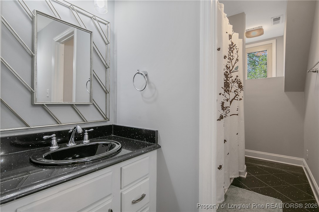 1915 Morganton Road Fayetteville, NC 28305 - Photo 32 of 48 a bathroom with a sink and a mirror