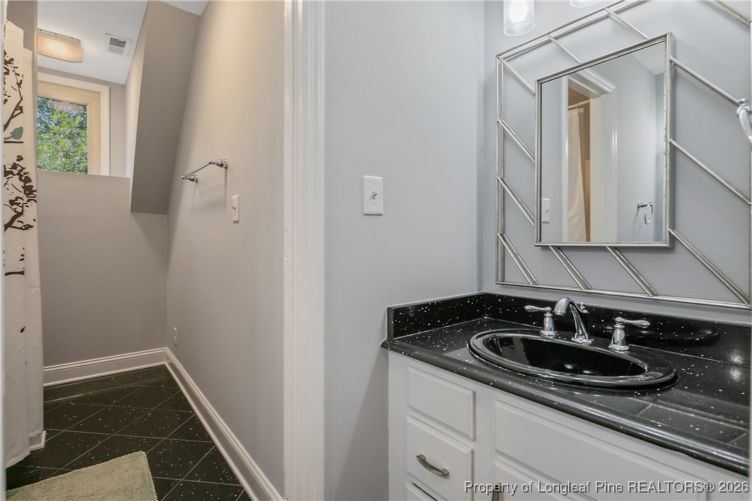 1915 Morganton Road Fayetteville, NC 28305 - Photo 33 of 48 a bathroom with a sink and a mirror