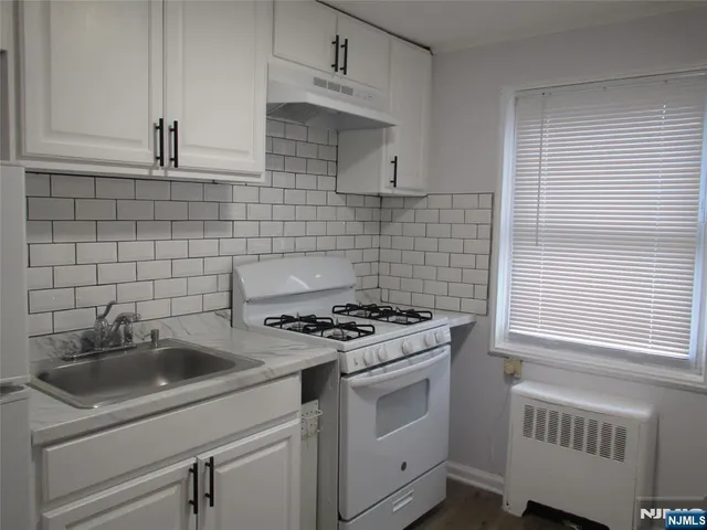 a kitchen that has a sink and a stove