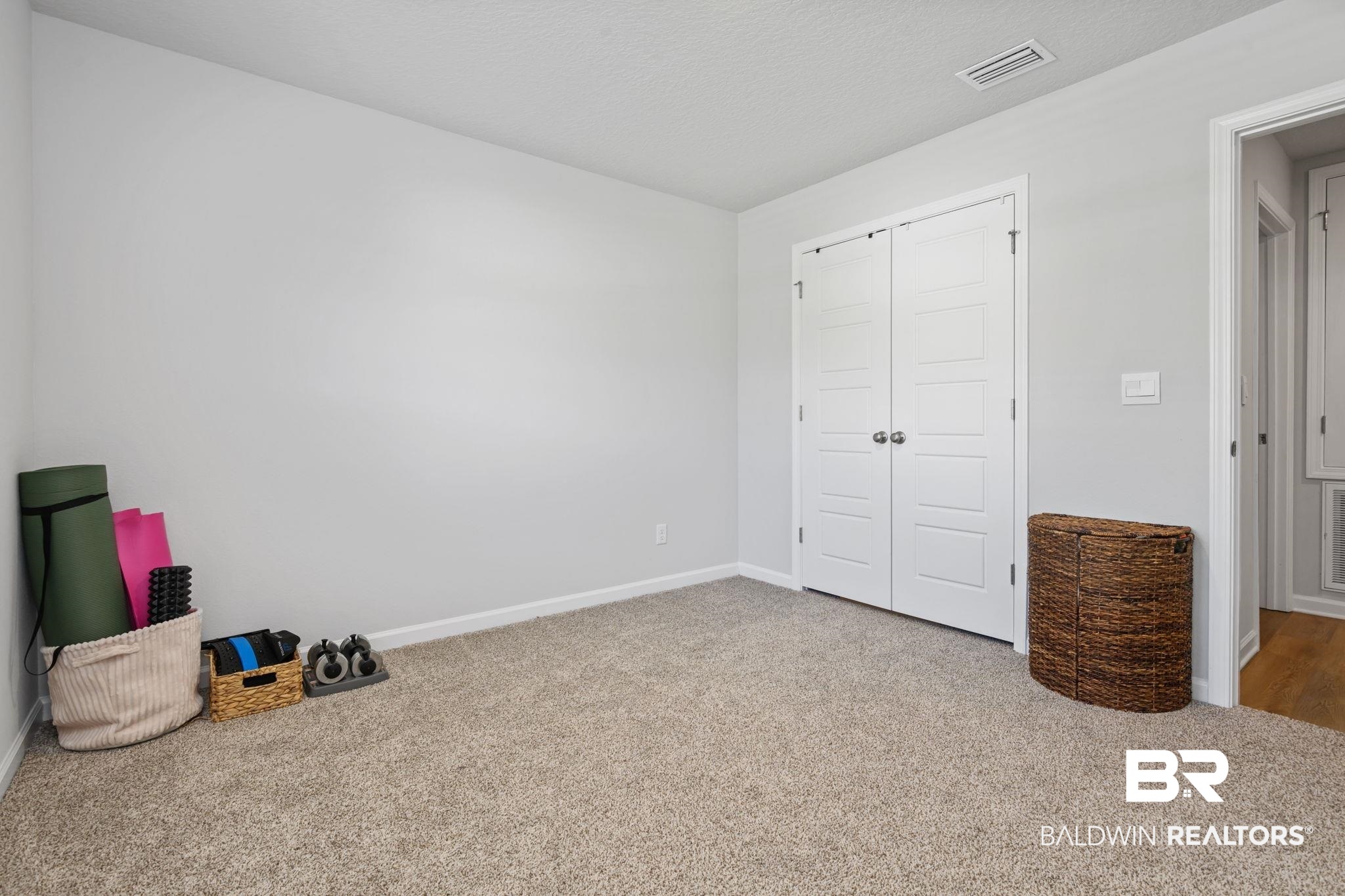 8021 Valor Rdg Way North Mobile, AL 36619 - Photo 20 of 34 Carpeted room with light gray walls, white trim, and a white bi-fold closet door