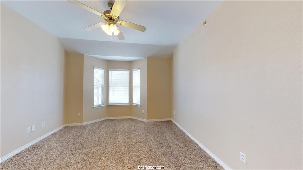 1198 Jones-Butler Road, Unit 706 College Station, TX 77840 - Photo 6 of 8 a view of a room with a window and a chandelier fan