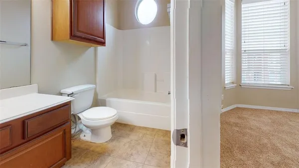 a bathroom with a toilet a sink and a mirror