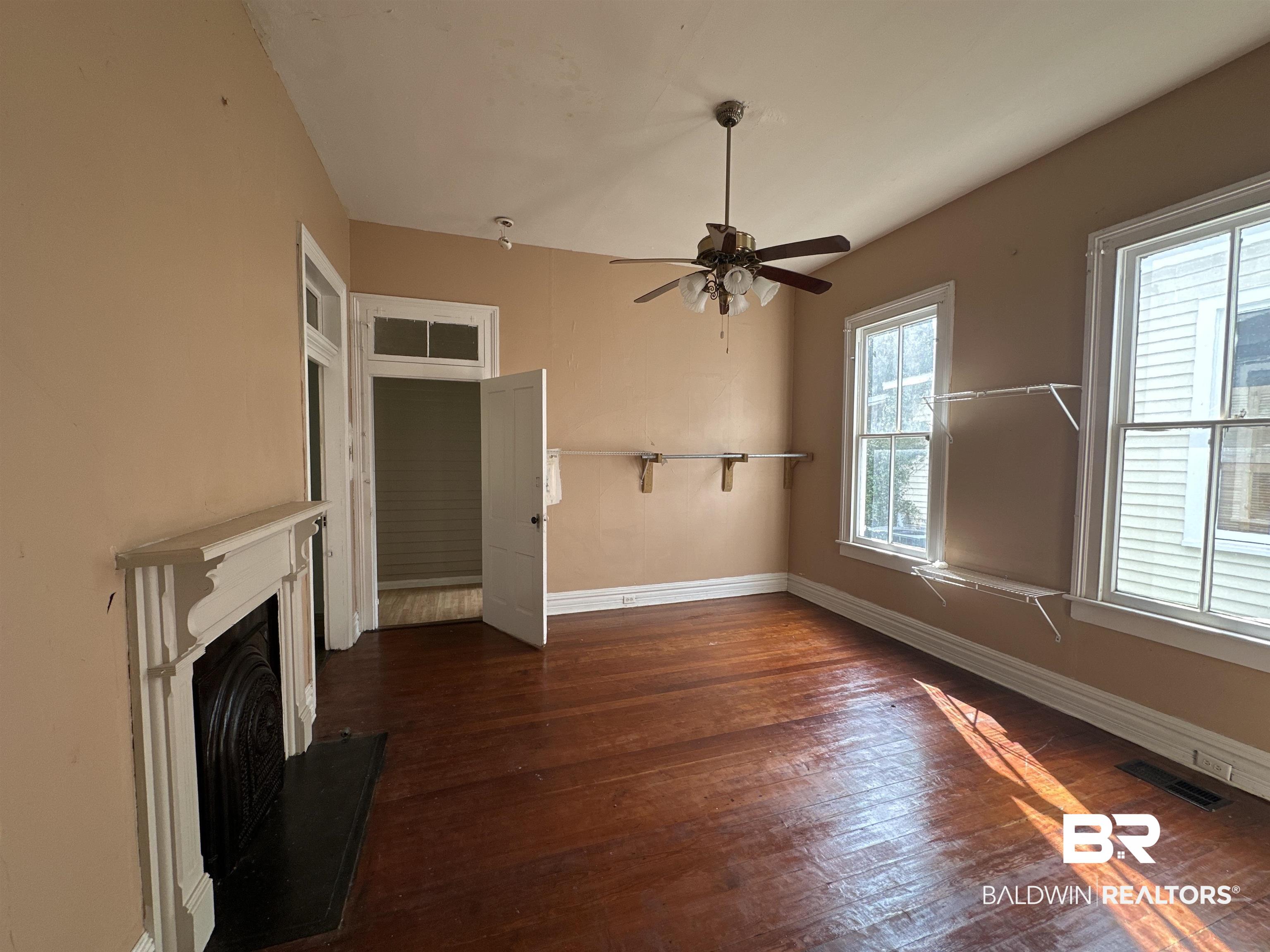 1119 Old Shell Road Mobile, AL 36604 - Photo 5 of 22 Unfurnished living room with ceiling fan and dark hardwood / wood-style floors
