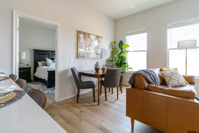 a living room with furniture wooden floor and a potted plant