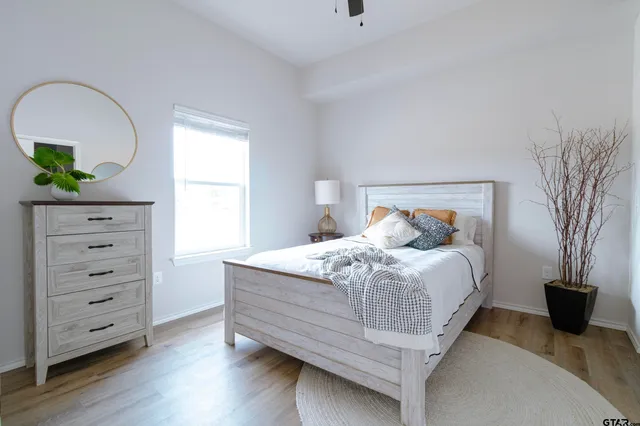 a bedroom with a bed and a potted plant