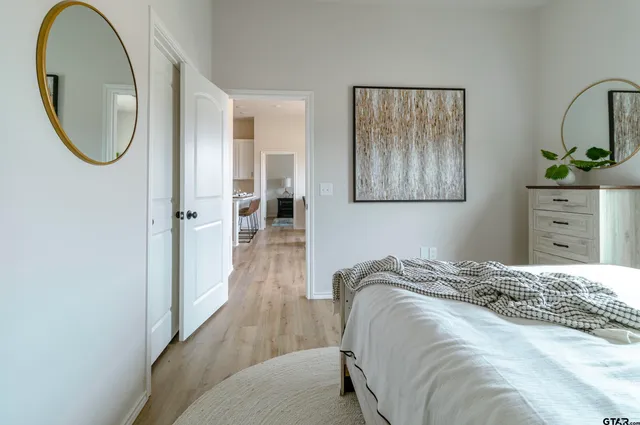 a bedroom with a bed and a mirror