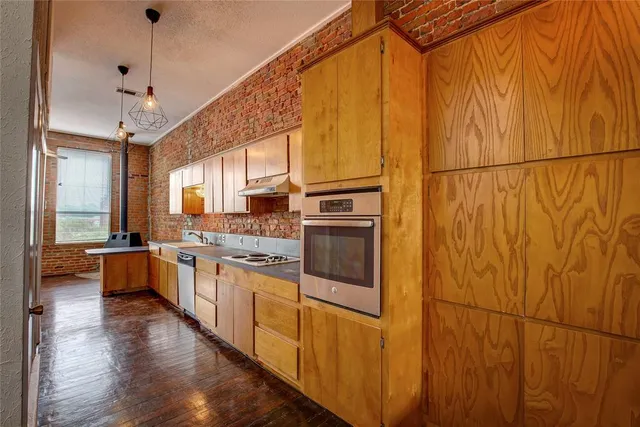 a kitchen with lots of counter top space and wooden floor