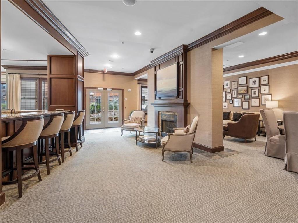 901 Abernathy Road Northeast, Unit 3200 Atlanta, GA 30328 - Photo 13 of 17 a living room with furniture a fireplace and large windows