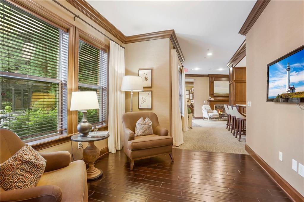 901 Abernathy Road Northeast, Unit 3200 Atlanta, GA 30328 - Photo 14 of 17 a living room with furniture and a large window