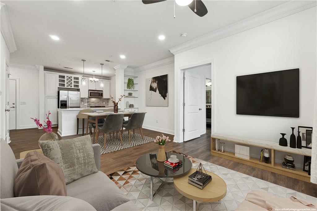 901 Abernathy Road Northeast, Unit 3200 Atlanta, GA 30328 - Photo 2 of 17 a living room with furniture and a flat screen tv