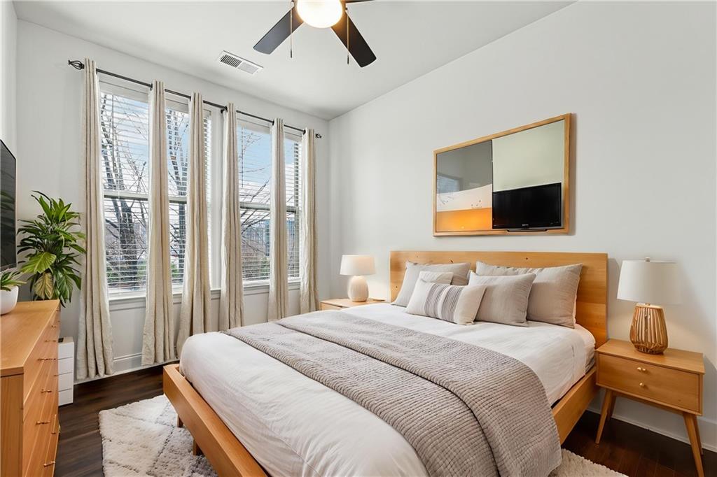 901 Abernathy Road Northeast, Unit 3200 Atlanta, GA 30328 - Photo 5 of 17 a bedroom with a large bed and a flat tv screen
