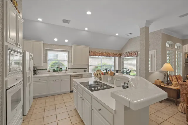 a kitchen with sink cabinets and window
