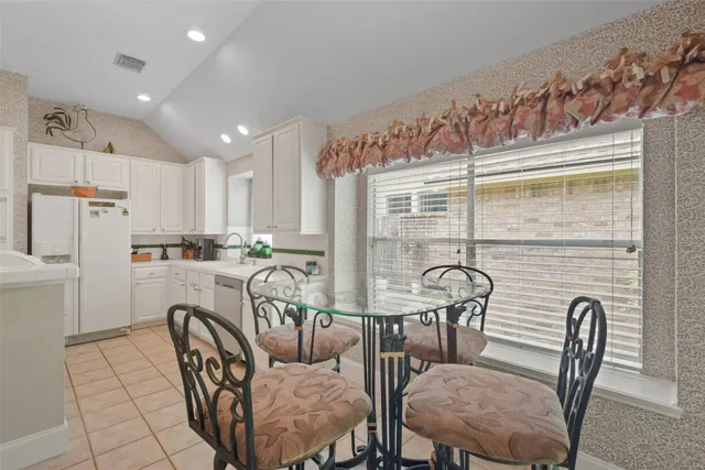 a dining room with furniture and window