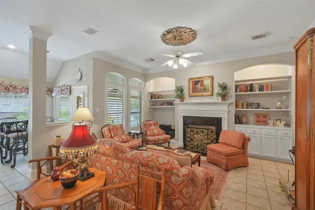 a living room with furniture fireplace and window