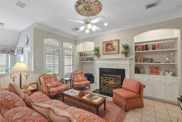 a living room with furniture a fireplace and a large mirror