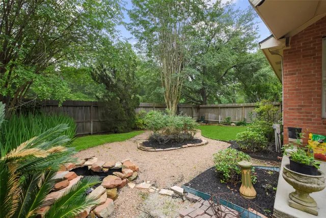 a view of a garden with wooden fence
