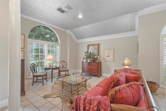 a living room with furniture and large windows